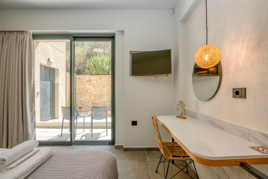 Peaceful bedroom with plush bedding, rattan lamp, and contemporary Mediterranean aesthetic at Nusa Gramvousa villa, Crete