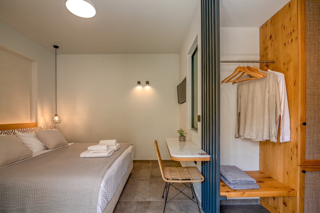 Spacious airy bedroom with high ceilings, natural materials, and Mediterranean design at Nusa Gramvousa villa, Crete