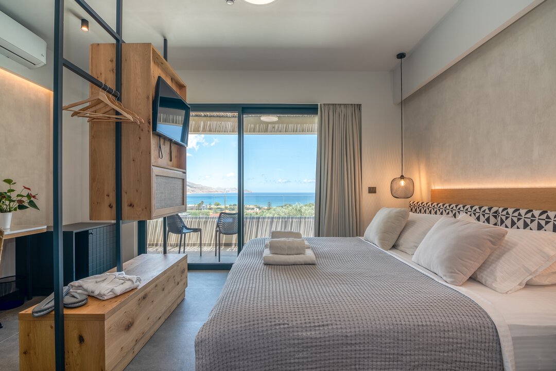 Premium bedroom with quality linens, sea views, and Mediterranean styling at Nusa Falassarna villa, Crete
