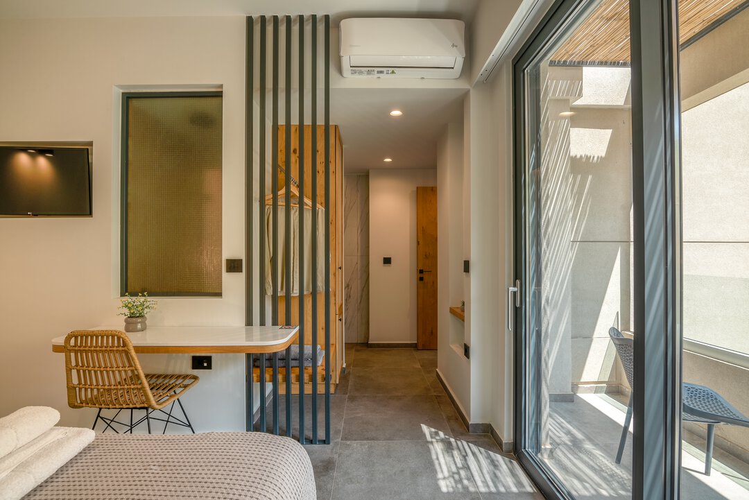 Designer bedroom with custom headboard and pendant lighting at Nusa Balos villa, Crete