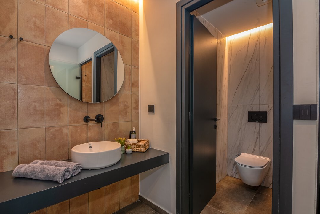 Contemporary bathroom with vessel sink and terracotta tiles at Nusa Balos villa near Balos, Crete
