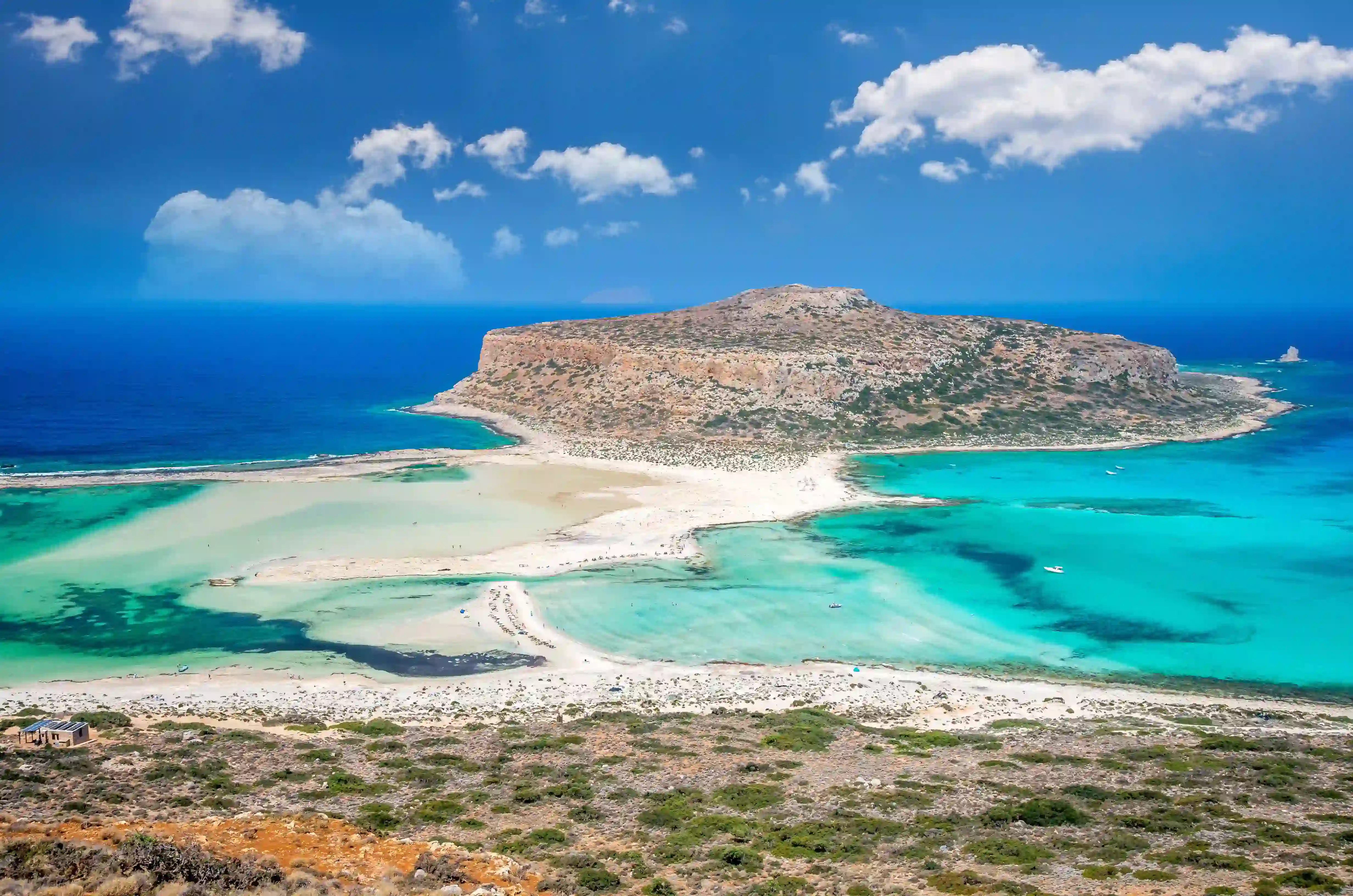 Aerial view of famous Balos Lagoon with turquoise waters, white sand beach, and Gramvousa peninsula, Crete